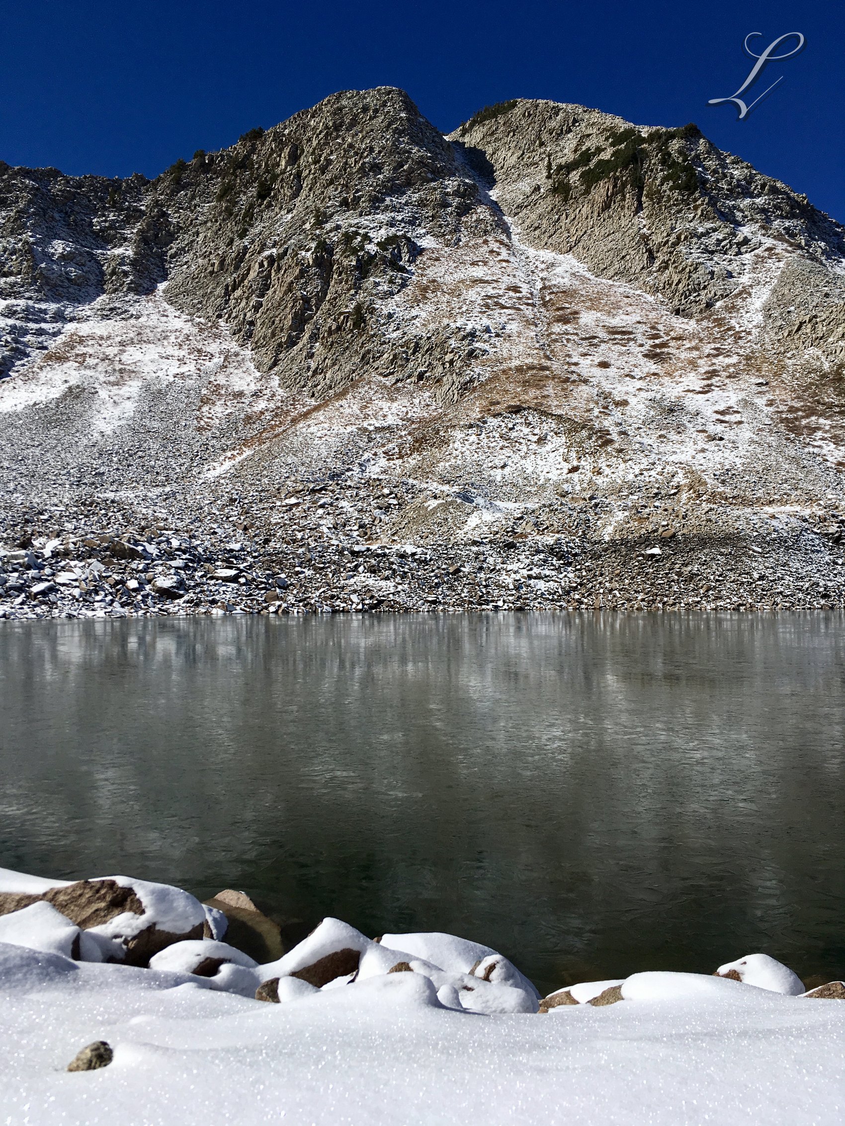White Pine Lake After Snow, an alpine lake beneath stone and early snow